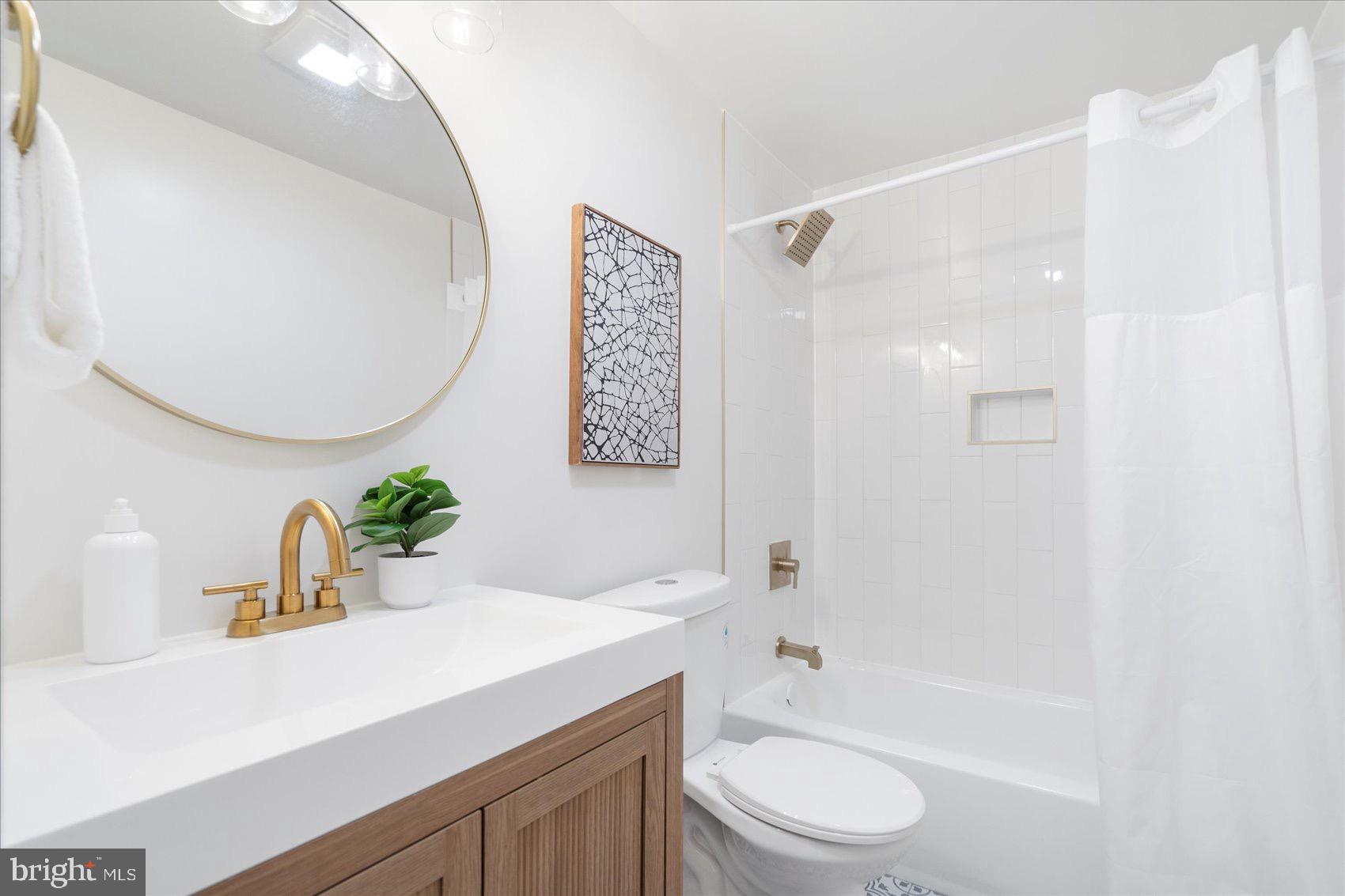 5425 Balistan Road Rosedale, MD 21237 - Photo 19 of 39 a bathroom with a sink a toilet and shower