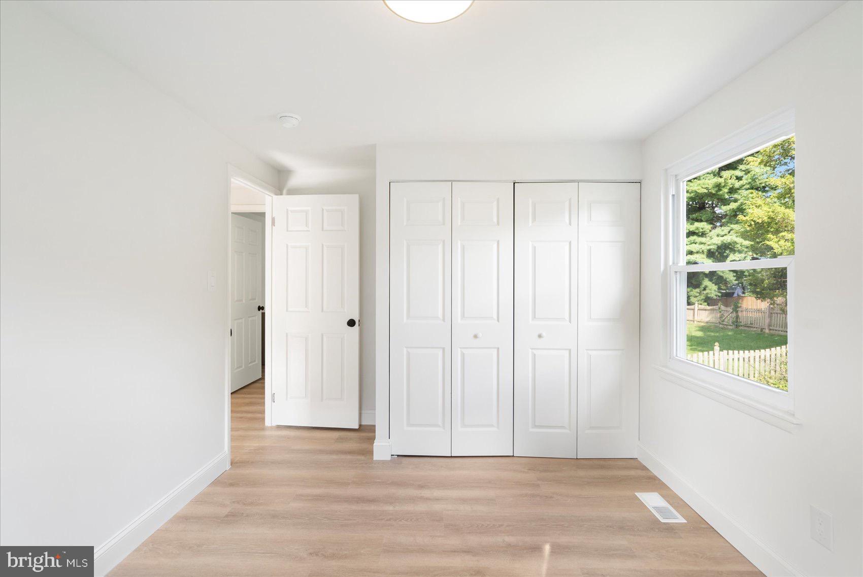 5425 Balistan Road Rosedale, MD 21237 - Photo 26 of 39 a view of an empty room with wooden floor and a window