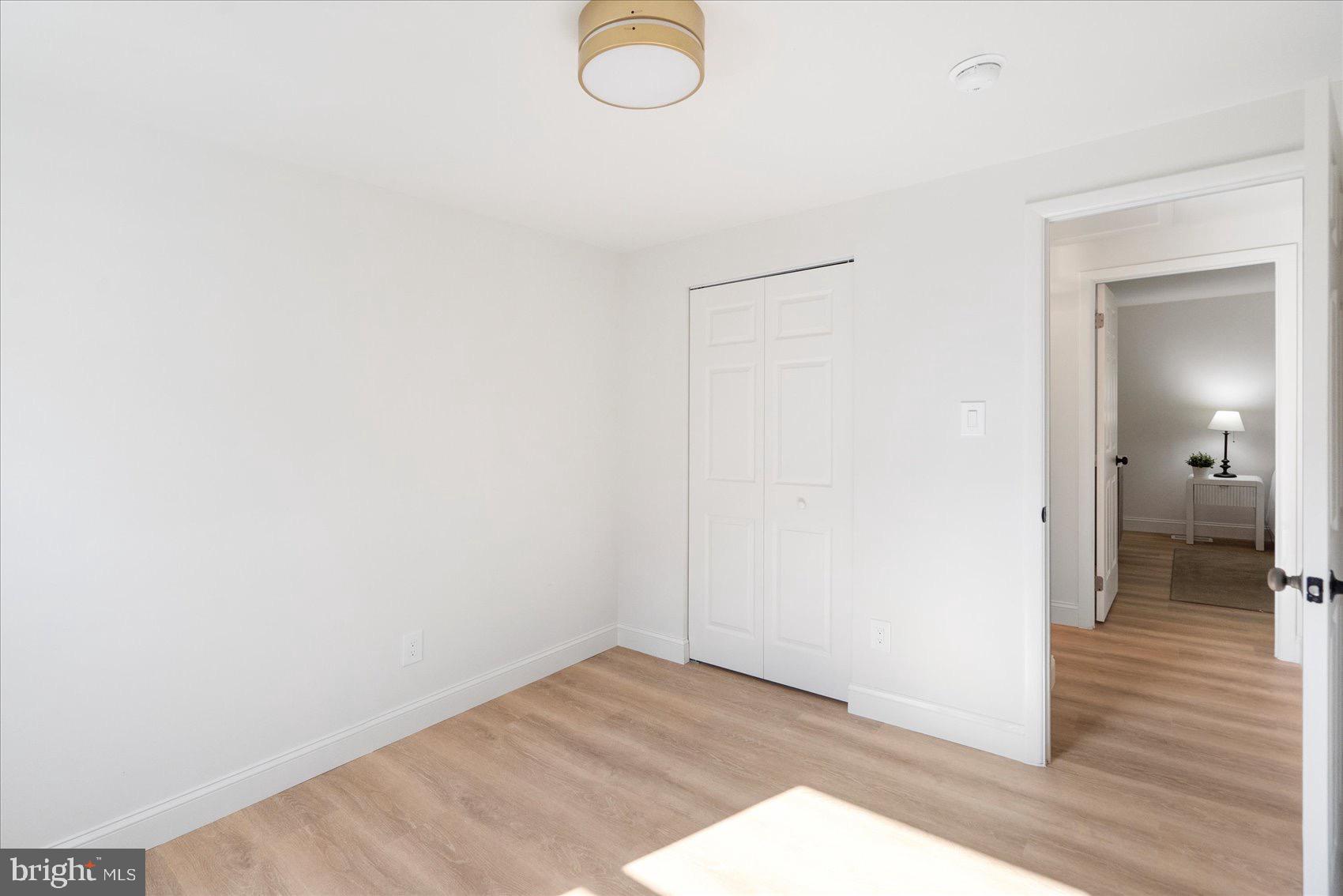 5425 Balistan Road Rosedale, MD 21237 - Photo 28 of 39 a view of a room with wooden floor and mirror