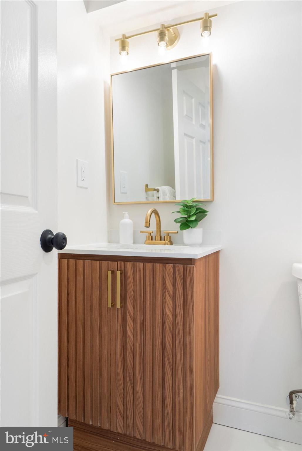 5425 Balistan Road Rosedale, MD 21237 - Photo 37 of 39 a bathroom with a sink and a mirror