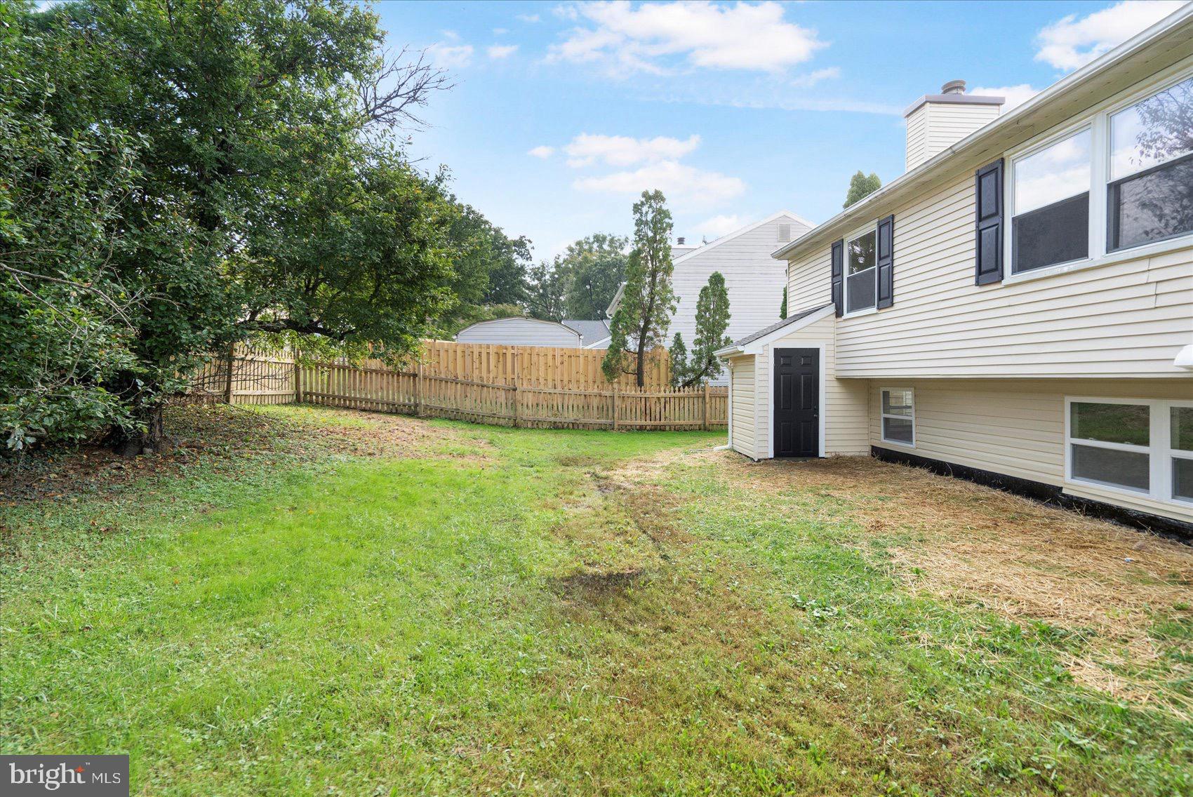 5425 Balistan Road Rosedale, MD 21237 - Photo 8 of 39 a view of a house with a backyard and a large tree