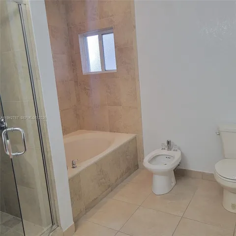 a bath room with a toilet and a bath tub