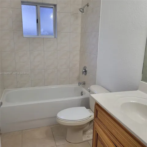 a bathroom with a sink a toilet and bathtub