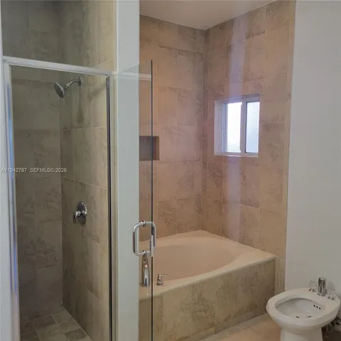 a bath room with a bath tub and a shower