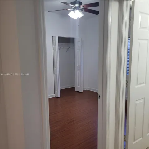 a view of a chandelier fan and entryway
