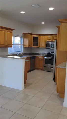 a kitchen with stainless steel appliances granite countertop a sink and cabinets