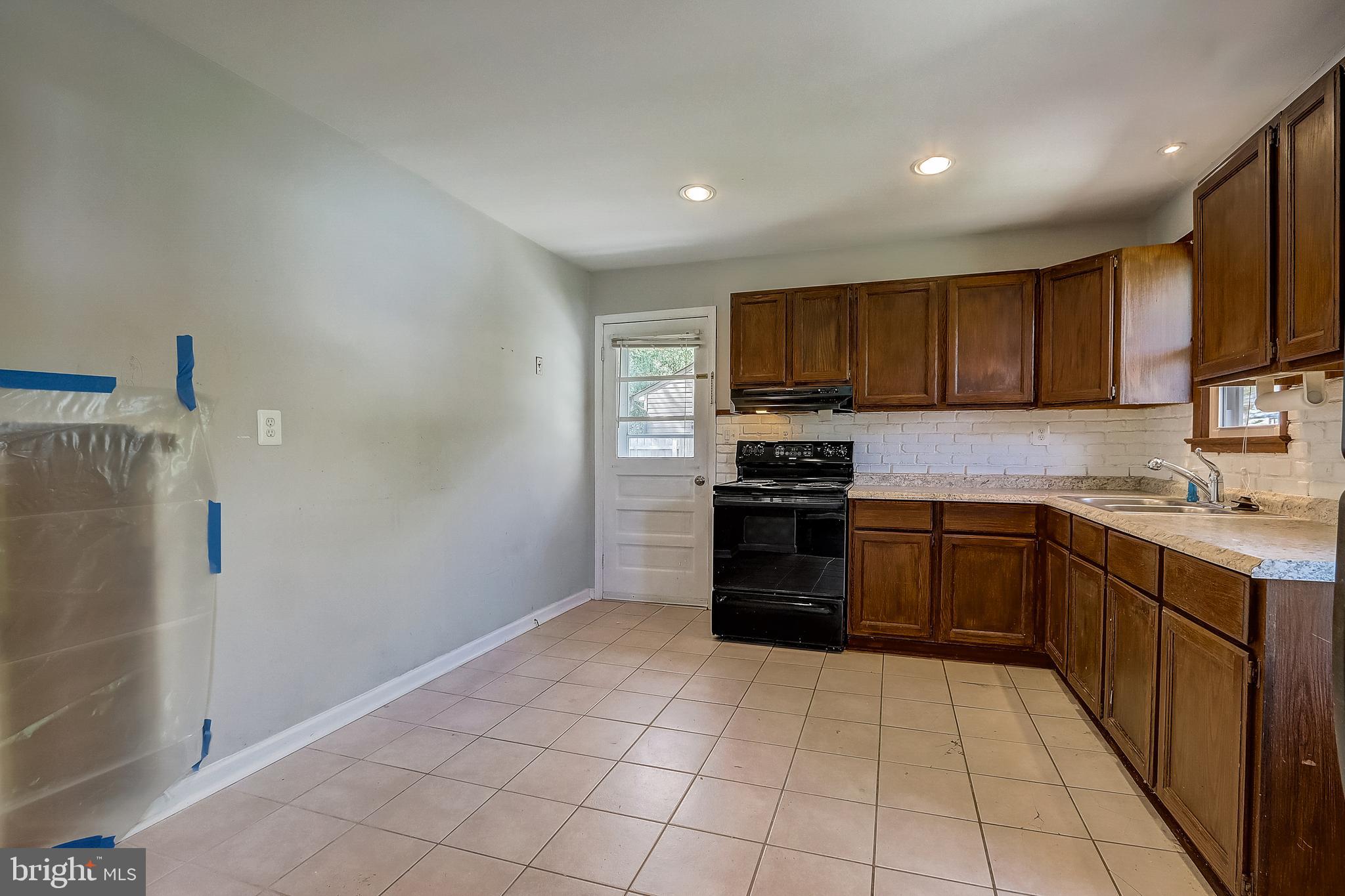 13221 Pine Road Bowie, MD 20720 - Photo 12 of 34 a kitchen with stainless steel appliances granite countertop a refrigerator and a stove top oven