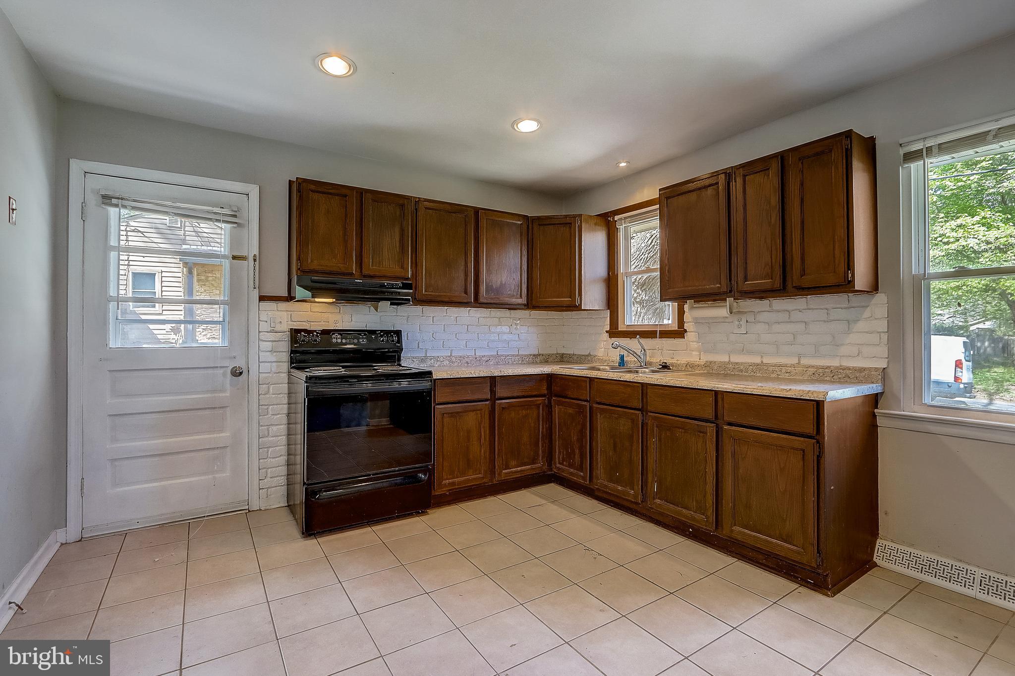 13221 Pine Road Bowie, MD 20720 - Photo 13 of 34 a kitchen with stainless steel appliances granite countertop a stove sink and cabinets