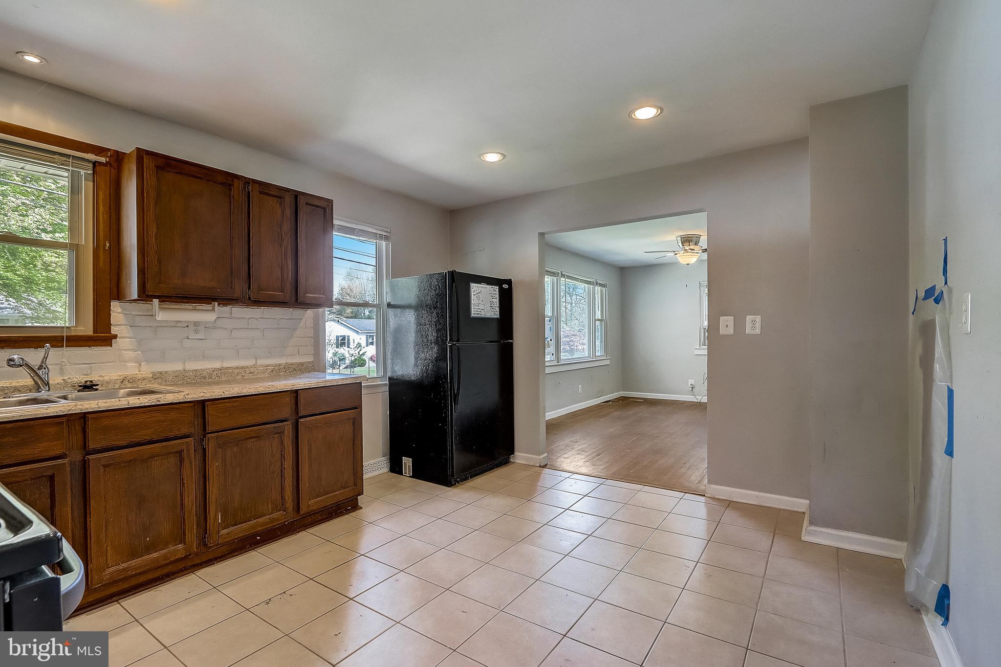 13221 Pine Road Bowie, MD 20720 - Photo 14 of 34 a kitchen with granite countertop a refrigerator and a sink
