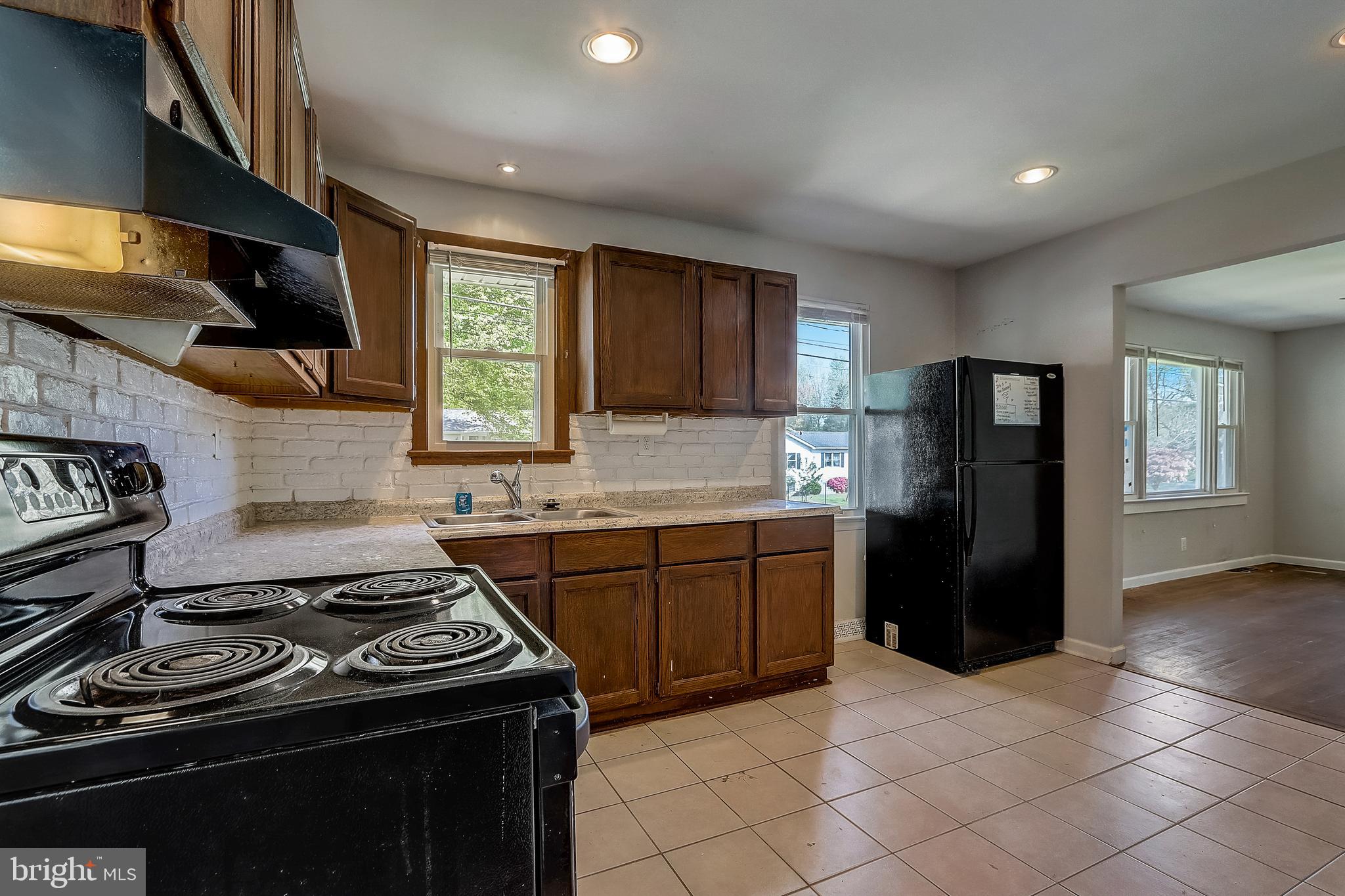 13221 Pine Road Bowie, MD 20720 - Photo 15 of 34 a kitchen with a stove and a refrigerator