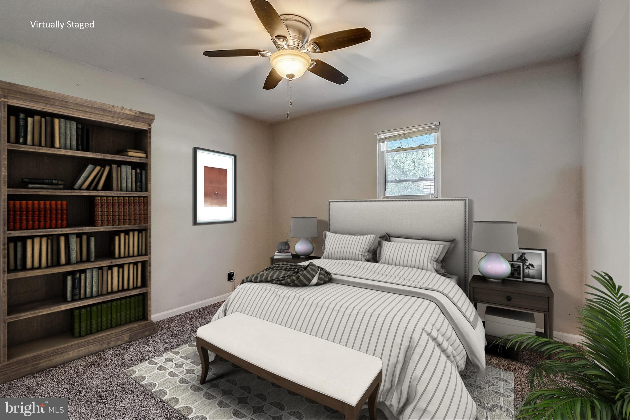 13221 Pine Road Bowie, MD 20720 - Photo 16 of 34 a bedroom with a bed a book shelf and a book shelf