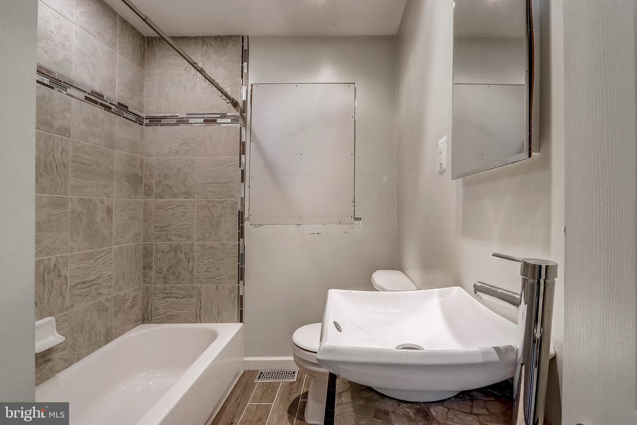 13221 Pine Road Bowie, MD 20720 - Photo 19 of 34 a bathroom with a sink toilet and shower