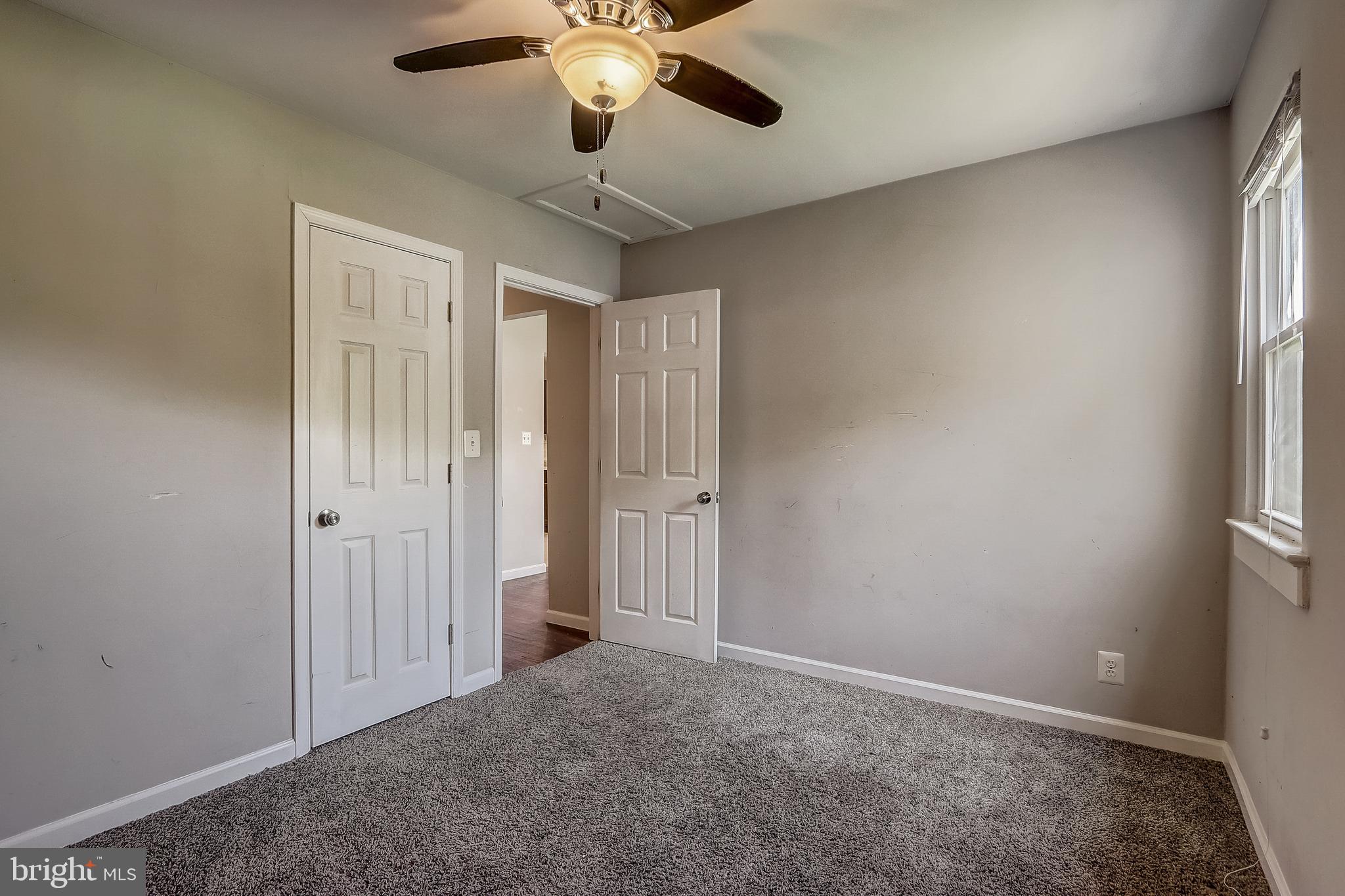 13221 Pine Road Bowie, MD 20720 - Photo 22 of 34 en empty room with windows and chandelier fan