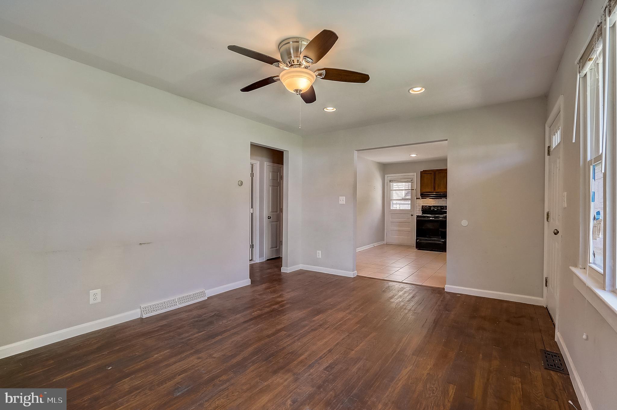13221 Pine Road Bowie, MD 20720 - Photo 6 of 34 a view of an empty room with wooden floor and a window