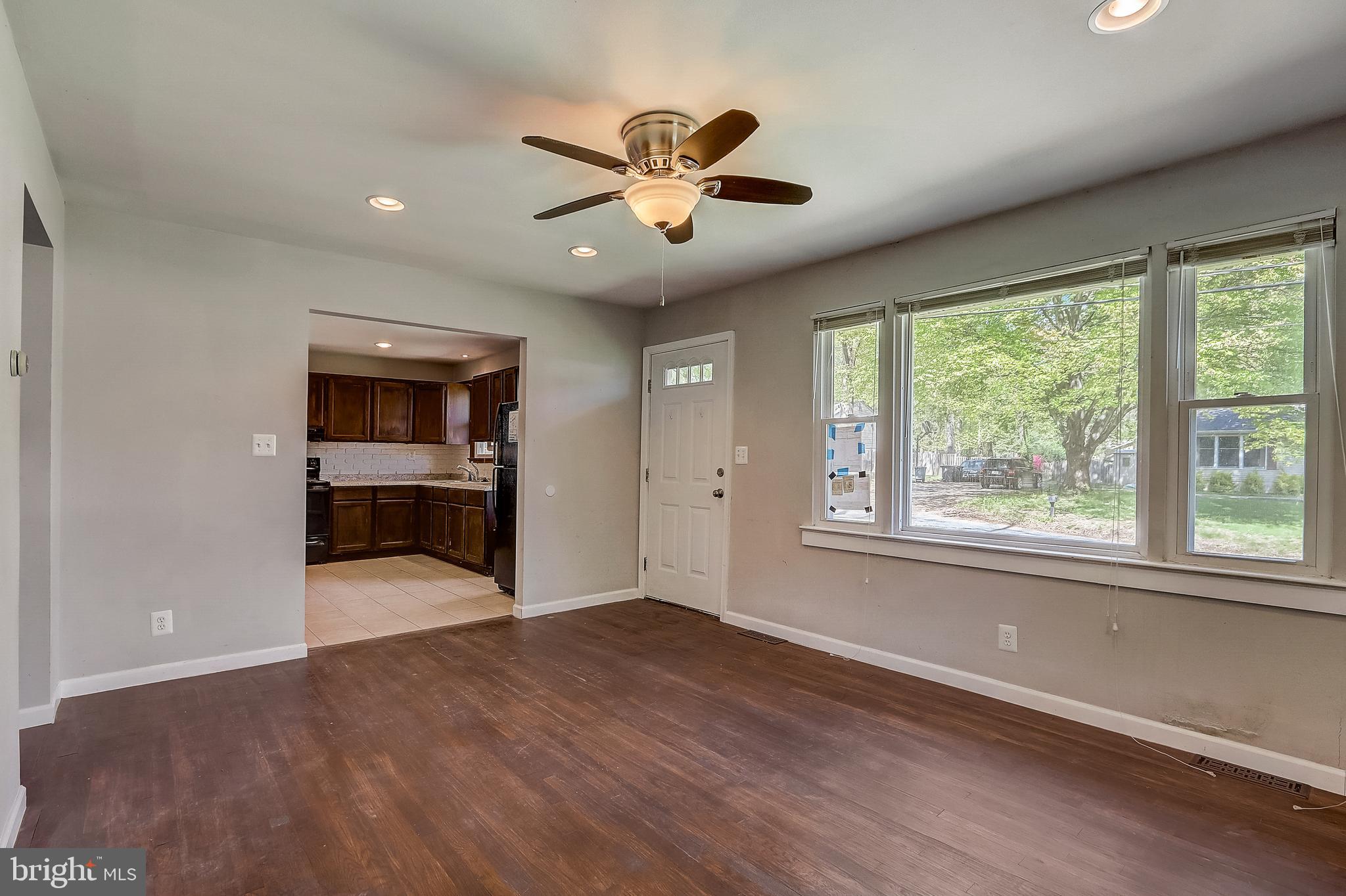 13221 Pine Road Bowie, MD 20720 - Photo 9 of 34 a view of an empty room with a window and wooden floor