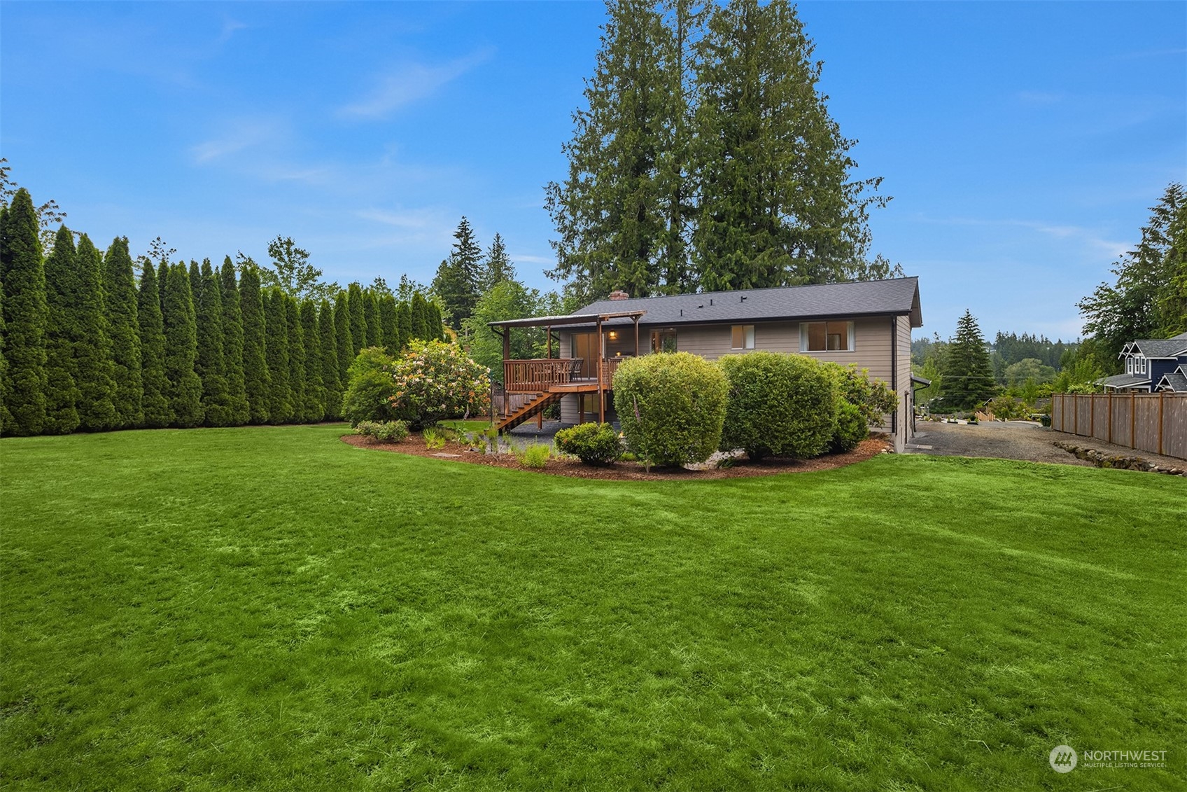 16604 3rd Avenue Southeast Bothell, WA 98012 - Photo 31 of 40 a view of a backyard with potted plants and large trees