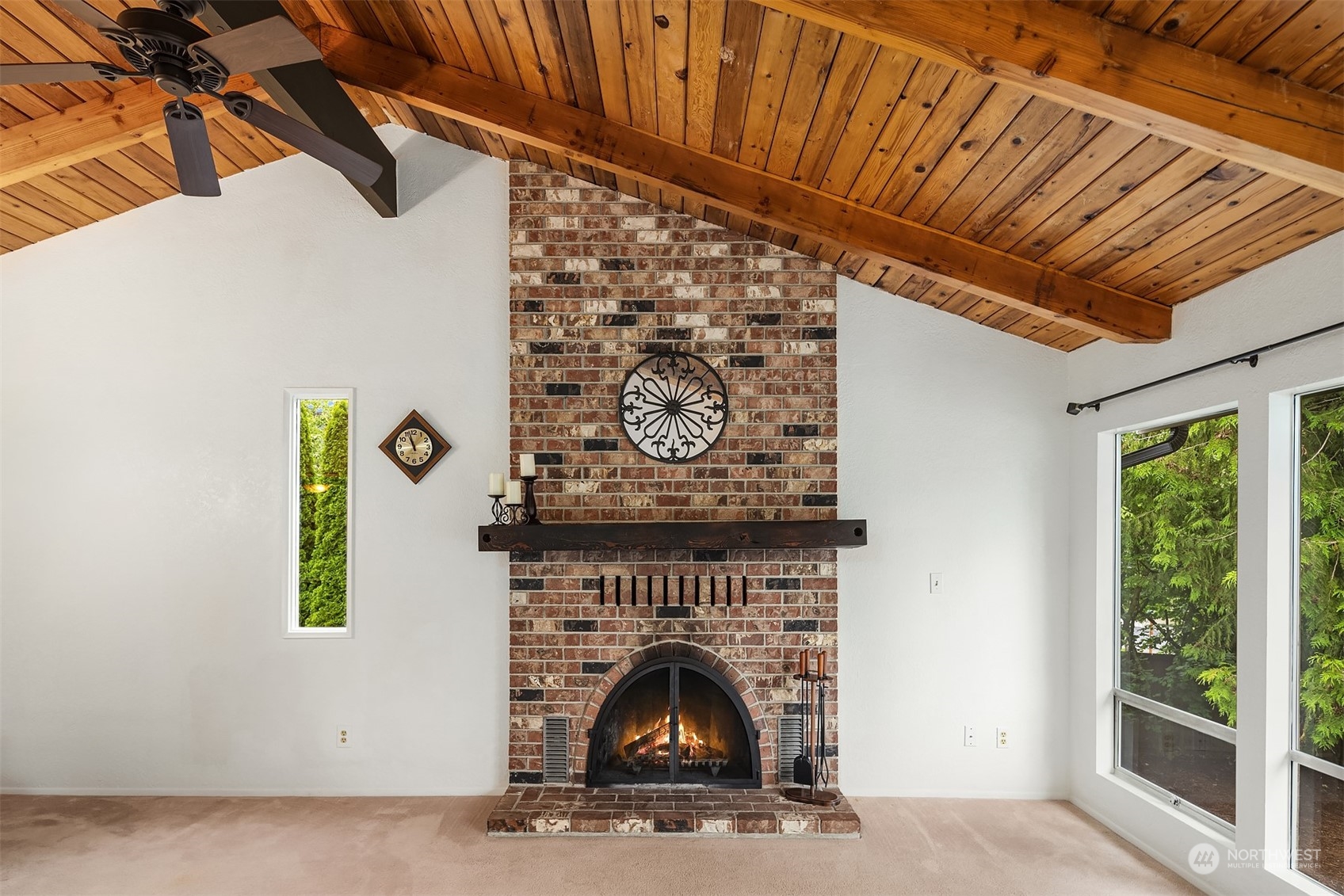 16604 3rd Avenue Southeast Bothell, WA 98012 - Photo 9 of 40 a living room with a fireplace and a clock