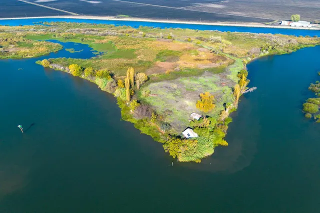 a view of a lake with lawn chairs