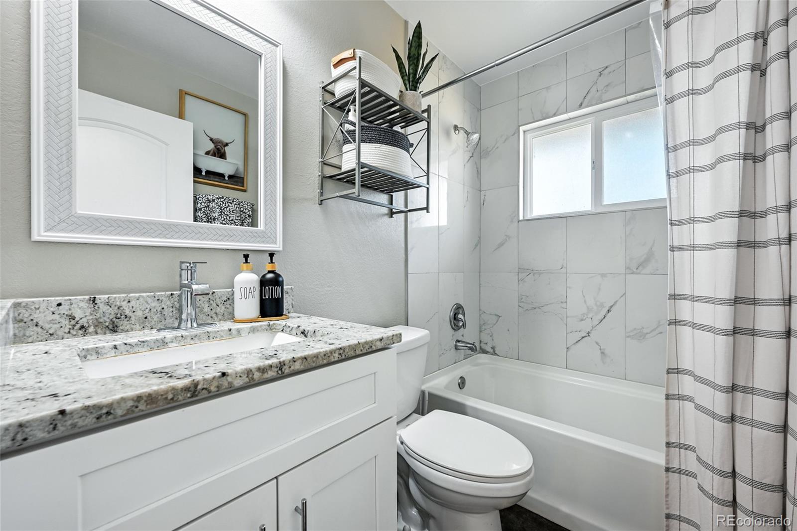 2714 South Raleigh Street Denver, CO 80236 - Photo 16 of 34 a bathroom with a granite countertop sink toilet and shower