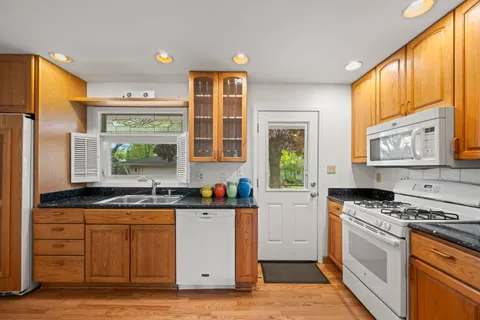 a kitchen with stainless steel appliances a stove sink and cabinets