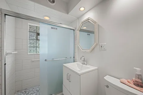 a bathroom with a sink toilet and shower