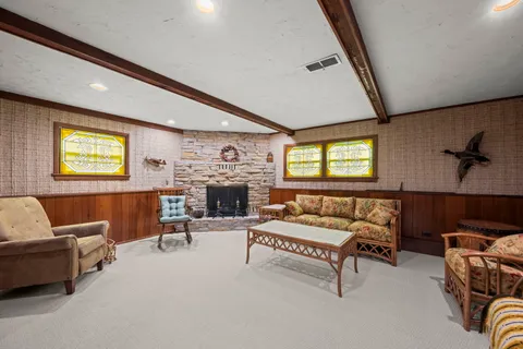 a living room with furniture and a fireplace
