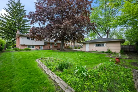 a view of house with backyard