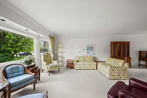 a bedroom with furniture and a large window
