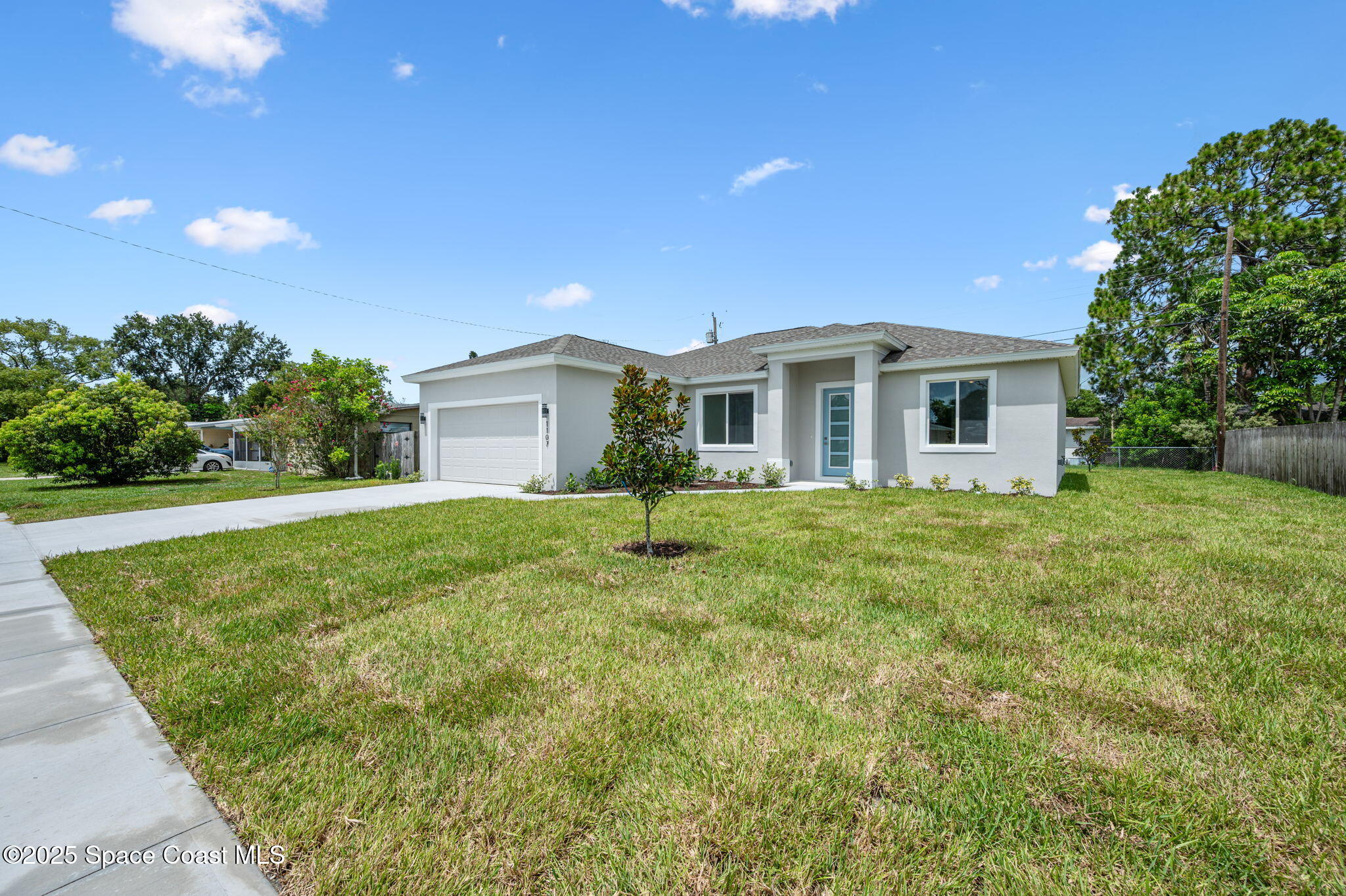 a front view of house with yard and green space
