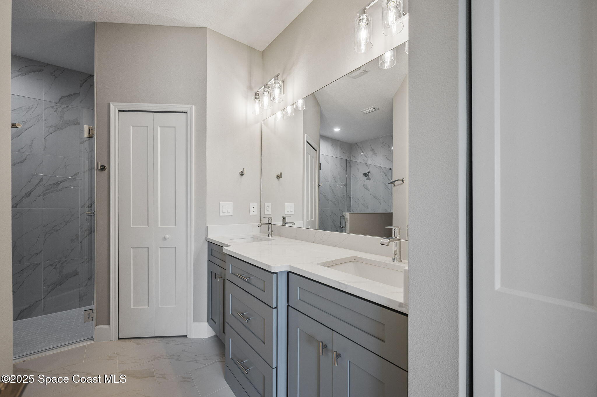 1107 Conquistador Drive Rockledge, FL 32955 - Photo 8 of 14 a bathroom with a double vanity sink and mirror