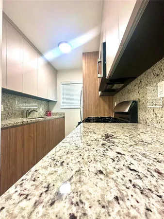 a view of a kitchen with furniture and wooden floor