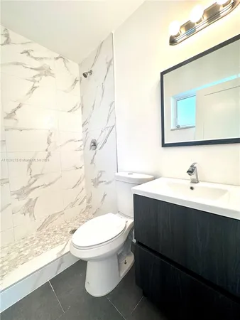 a bathroom with a sink a toilet and bathtub