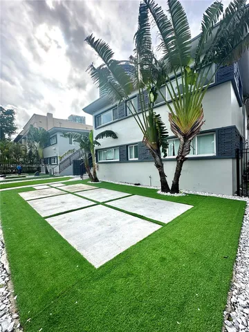 a view of a big yard with palm trees