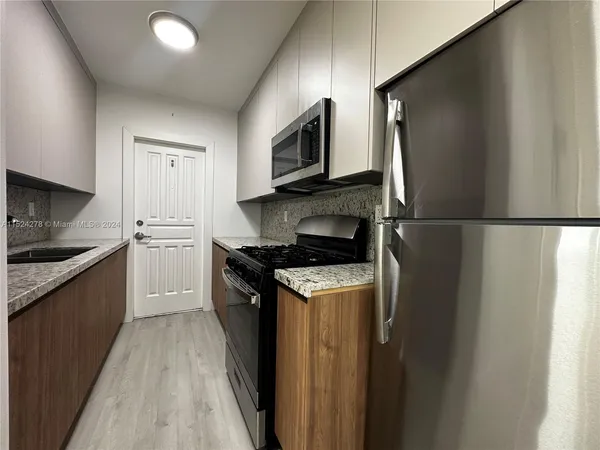 a kitchen with a sink and a counter top