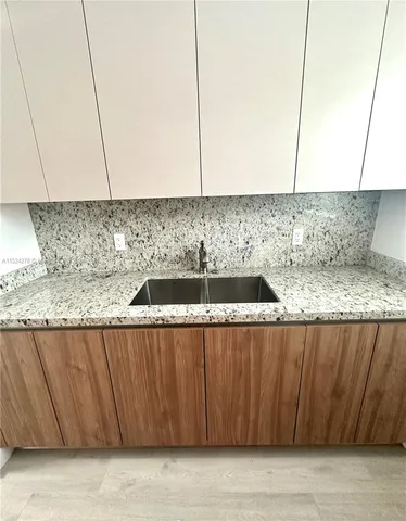 a kitchen with granite countertop a stove and a microwave