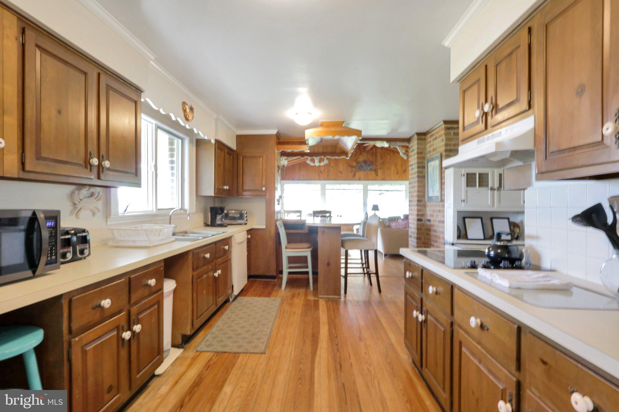 2598 Cherrystone Road Cape Charles, VA 23310 - Photo 20 of 47 Charming kitchen with warm wood tones.
