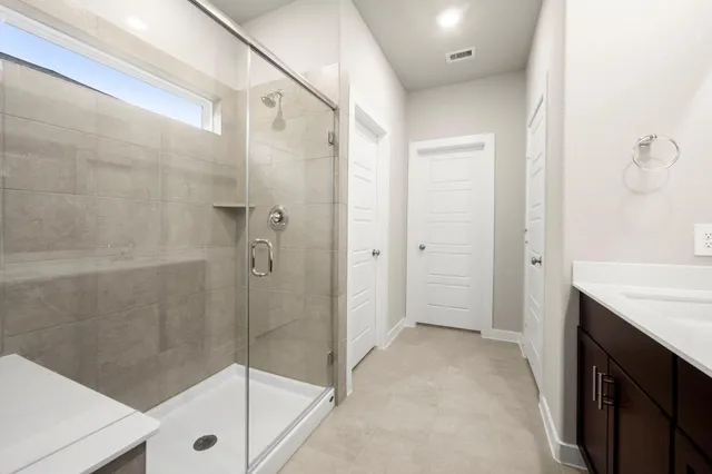 a bathroom with a shower and a sink