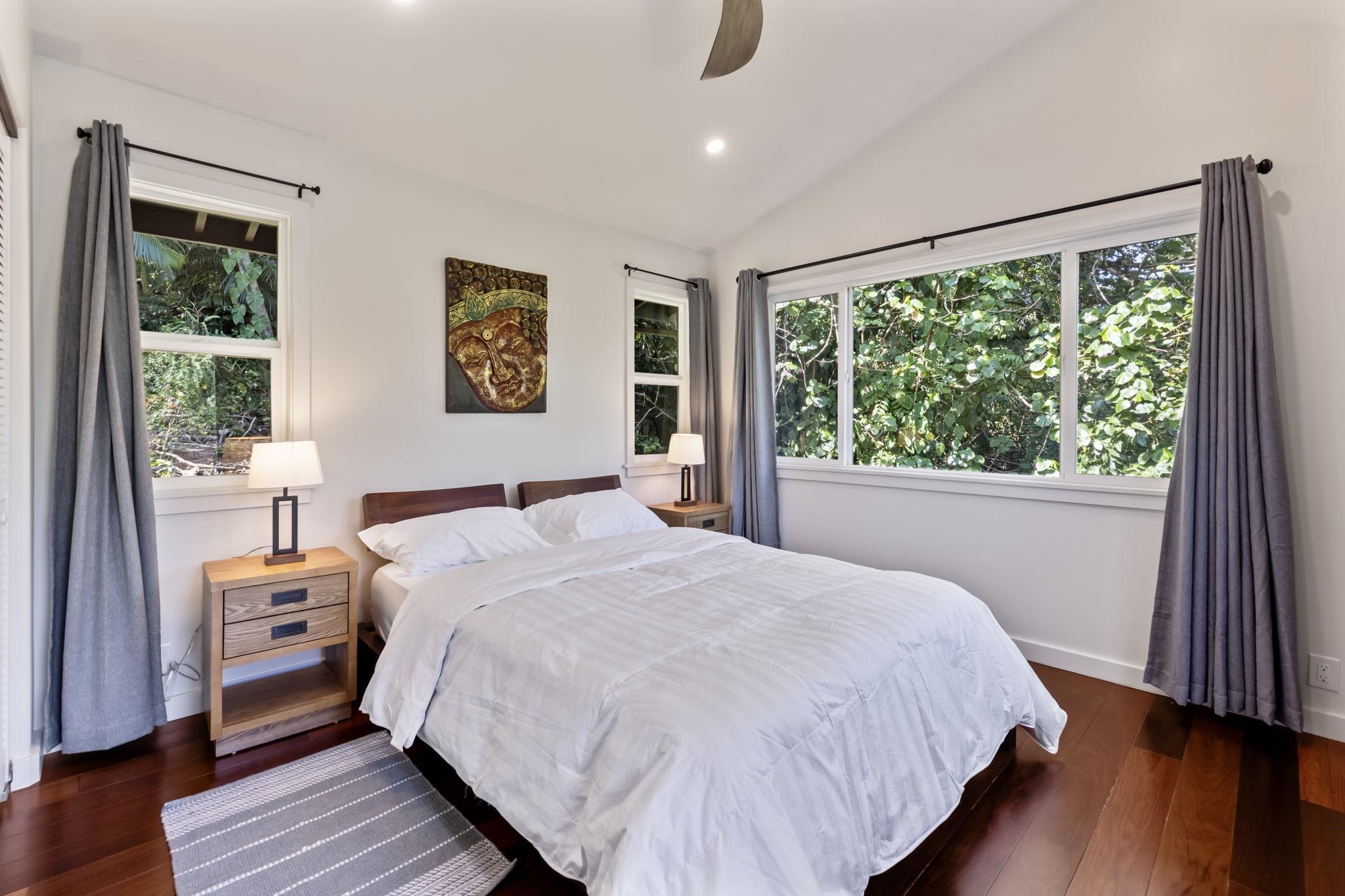 153 West Waipio Road Haiku, HI 96708 - Photo 8 of 15 a bedroom with a bed and a large window