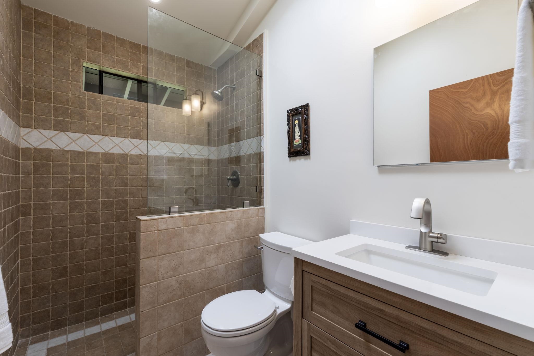 153 West Waipio Road Haiku, HI 96708 - Photo 10 of 15 a bathroom with a toilet a sink and mirror