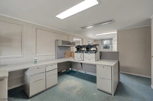 a kitchen with white cabinets and sink
