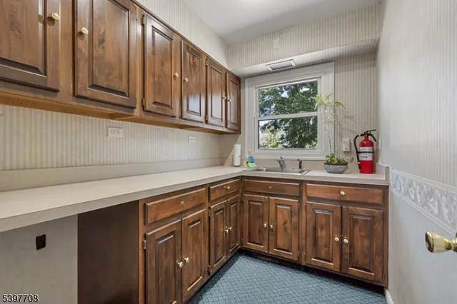 a kitchen with stainless steel appliances granite countertop a sink a cabinets and wooden floor