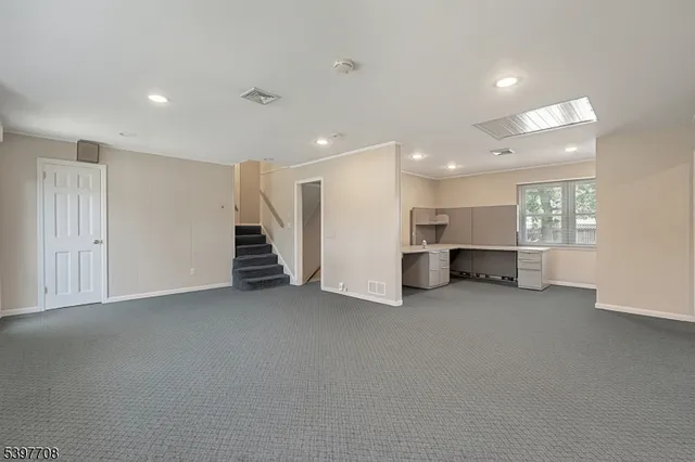 a view of a livingroom with furniture and stairs