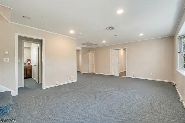 an empty room with closet and bathroom