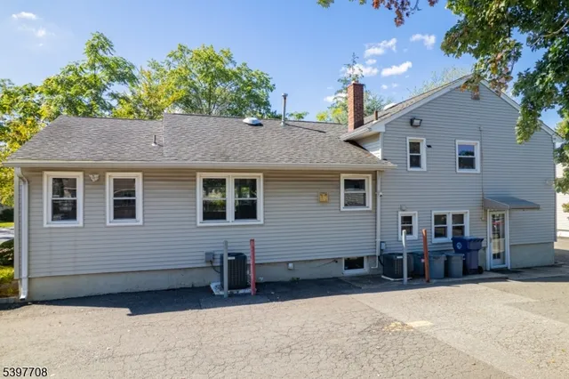 a view of a house with a backyard and a garage