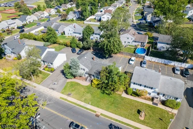 an aerial view of residential houses with outdoor space and street view