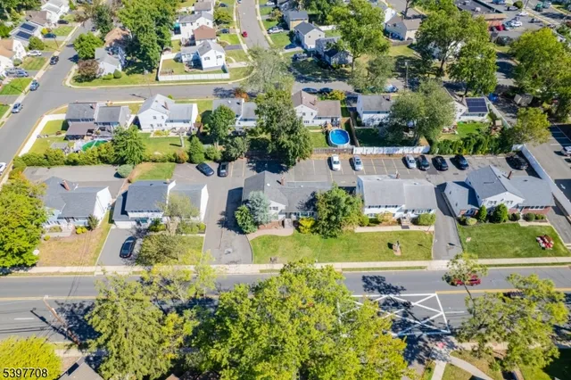 an aerial view of a house with a yard swimming pool and outdoor seating
