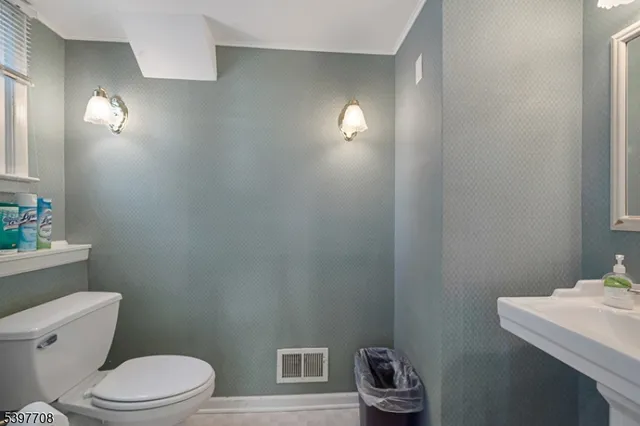 a bathroom with a toilet a sink and vanity