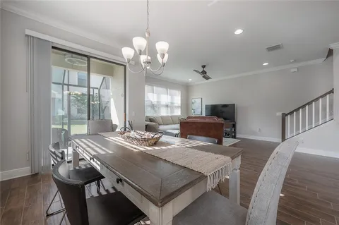 a view of a dining room with furniture wooden floor and chandelier