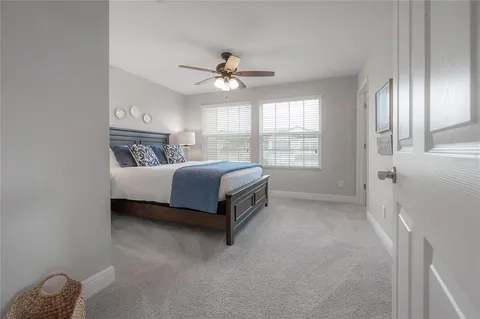a spacious bedroom with a bed and a chandelier