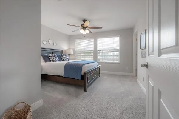 a spacious bedroom with a bed and a chandelier